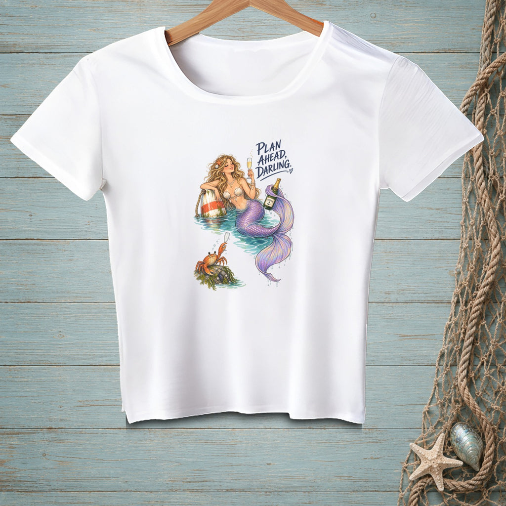 White t-shirt with mermaid and crab illustration, text "PLAN AHEAD, DARLING."
