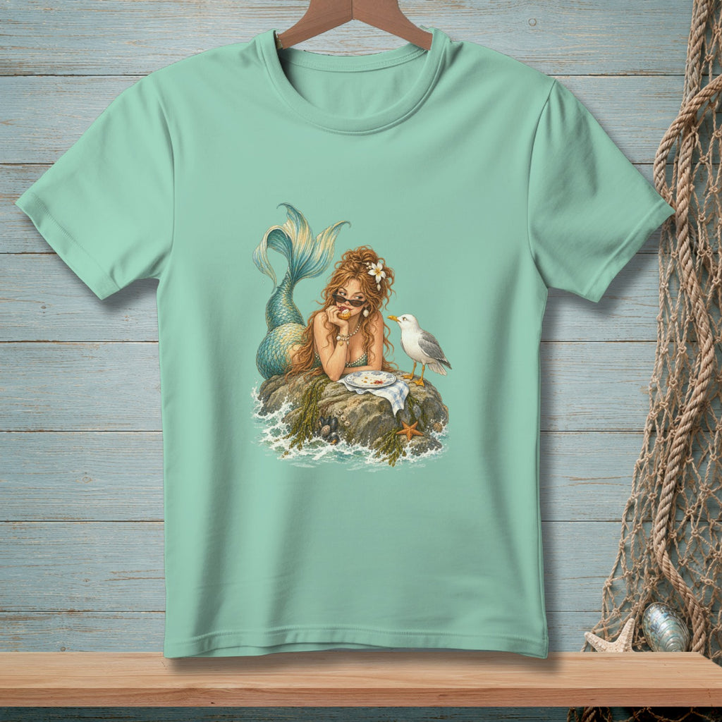 Mint t-shirt with a mermaid and seagull eating on a rock.