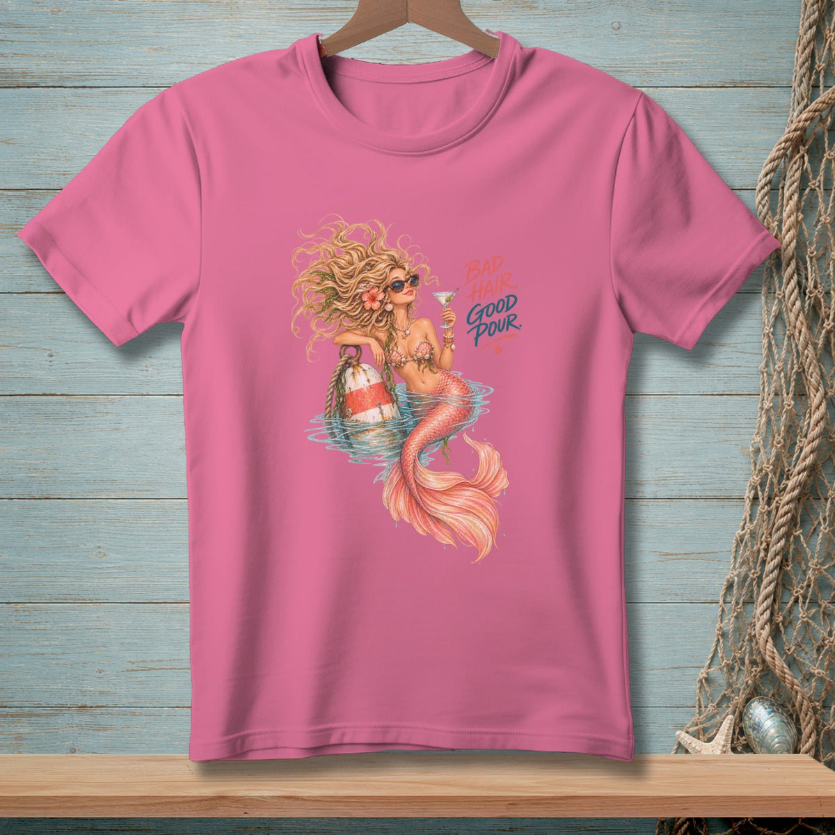 Mermaid with sunglasses holding a drink and a buoy with text "BAD HAIR GOOD POUR".