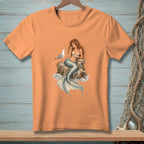 Orange t-shirt with a detailed illustration of a mermaid and seagull on a rock.