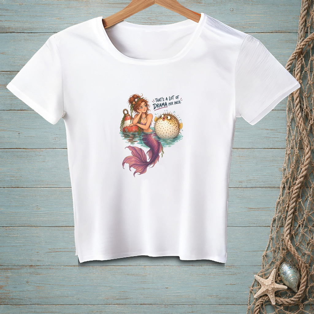 White t-shirt with a mermaid and pufferfish graphic and text.