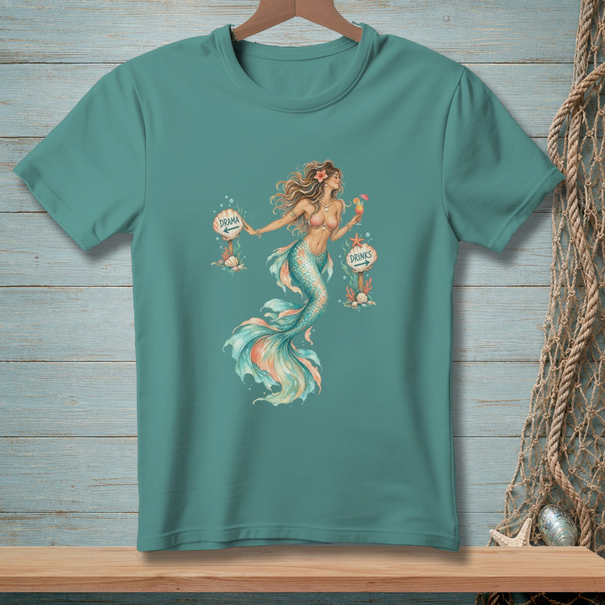 Teal t-shirt with mermaid graphic holding a drink and signs pointing to "Drama" and "Drinks".