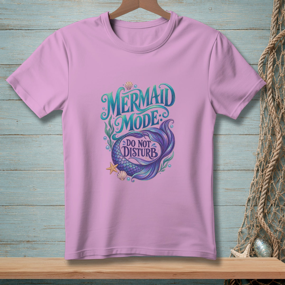 Lavender t-shirt with mermaid, seashells, and "Mermaid Mode: Do Not Disturb" text.