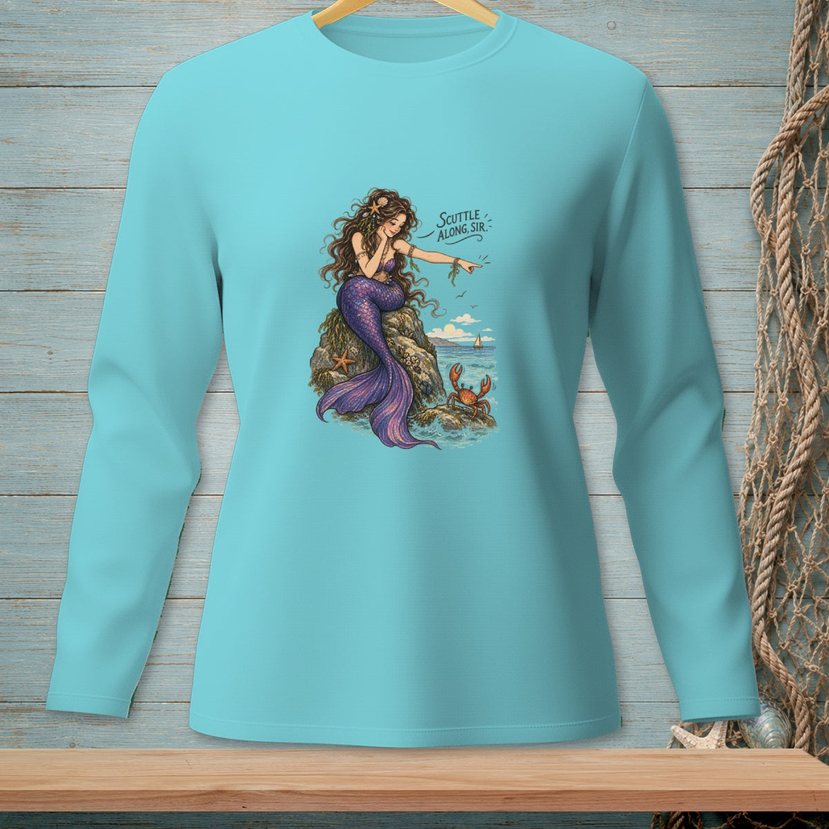 Aquatic themed graphic on a light blue long sleeve shirt with a mermaid and crab.