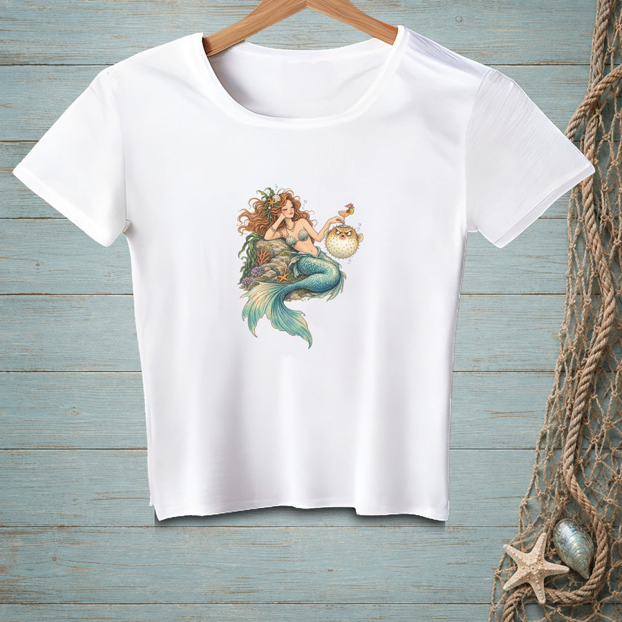 White t-shirt featuring a mermaid with a pufferfish and a cocktail.