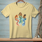 Three mermaids with colorful tails sit and drink cocktails together.