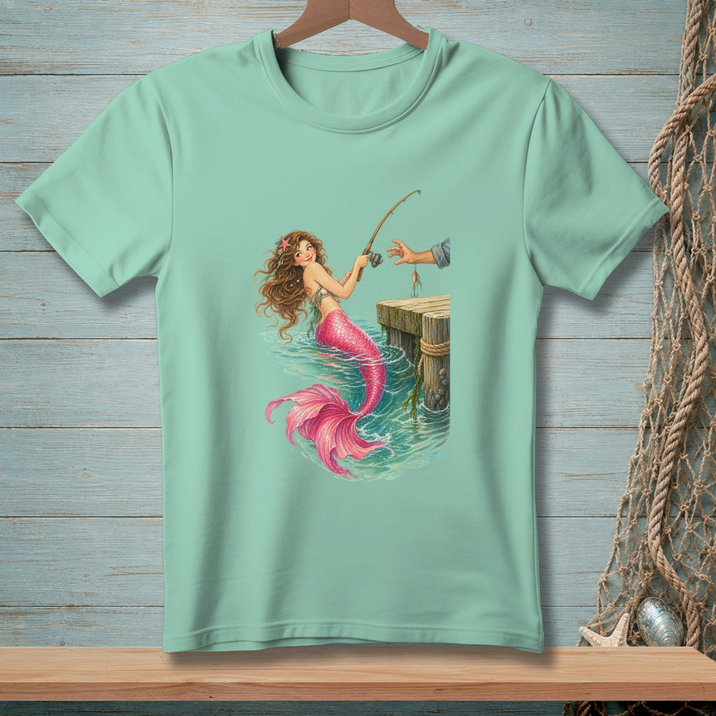 Mint t-shirt with mermaid fishing from a dock with a hand holding the fishing rod.