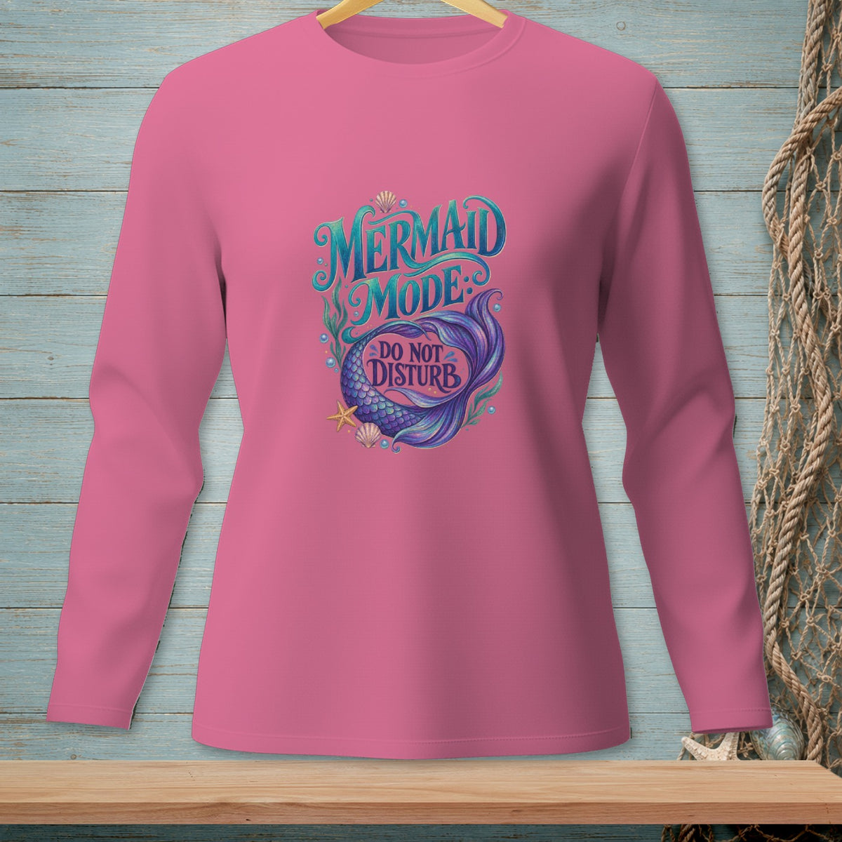Pink long-sleeved shirt with "Mermaid Mode: Do Not Disturb" and mermaid tail graphic.