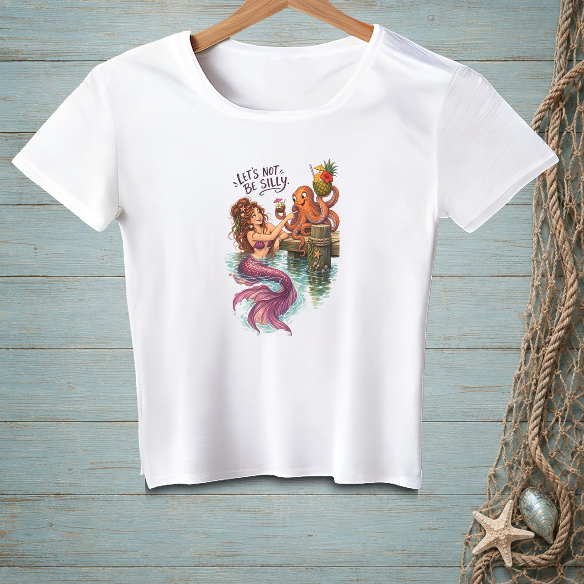White t-shirt with mermaid and octopus drinking cocktails and text "LET'S NOT BE SILLY."