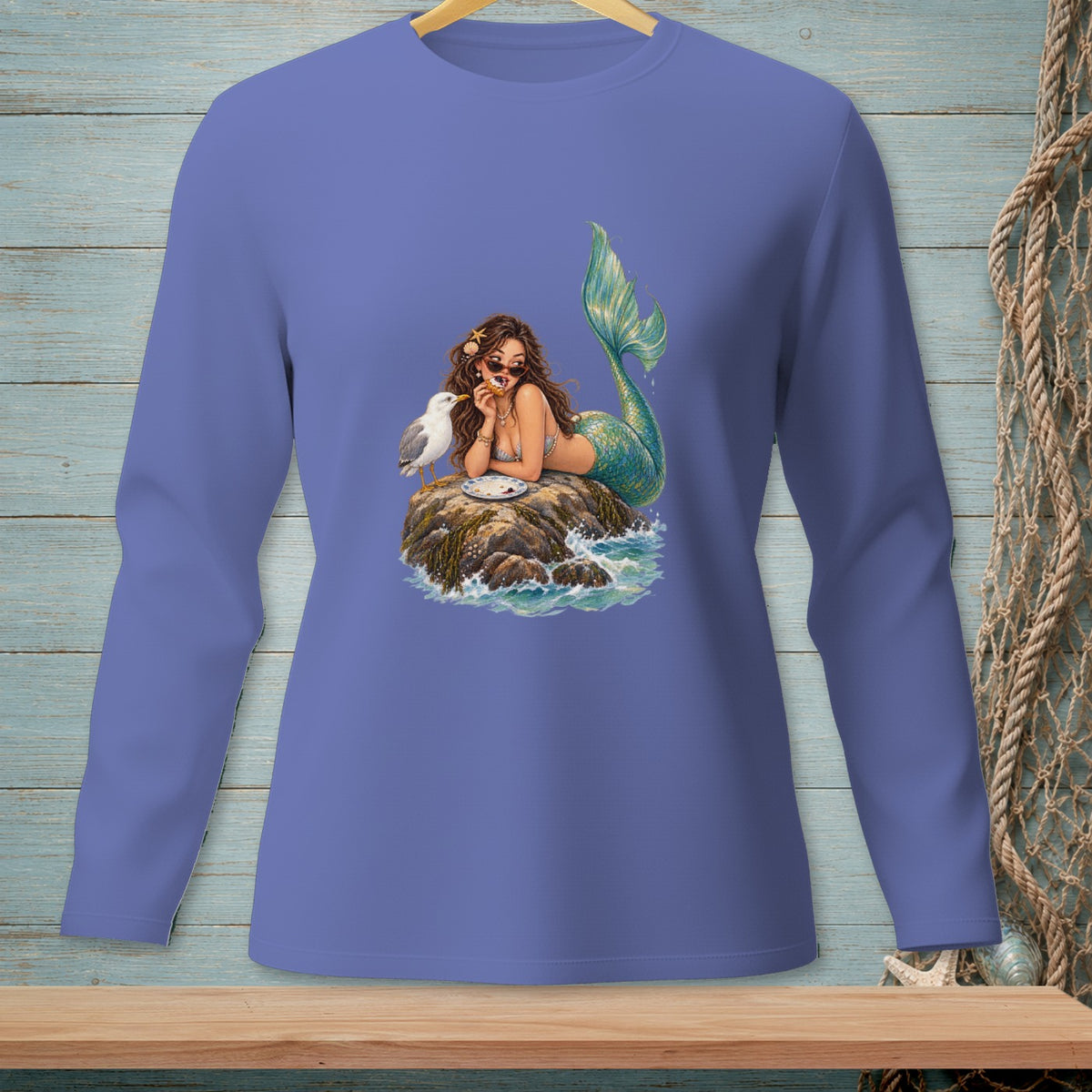 Mermaid on a rock with a seagull eating a donut.