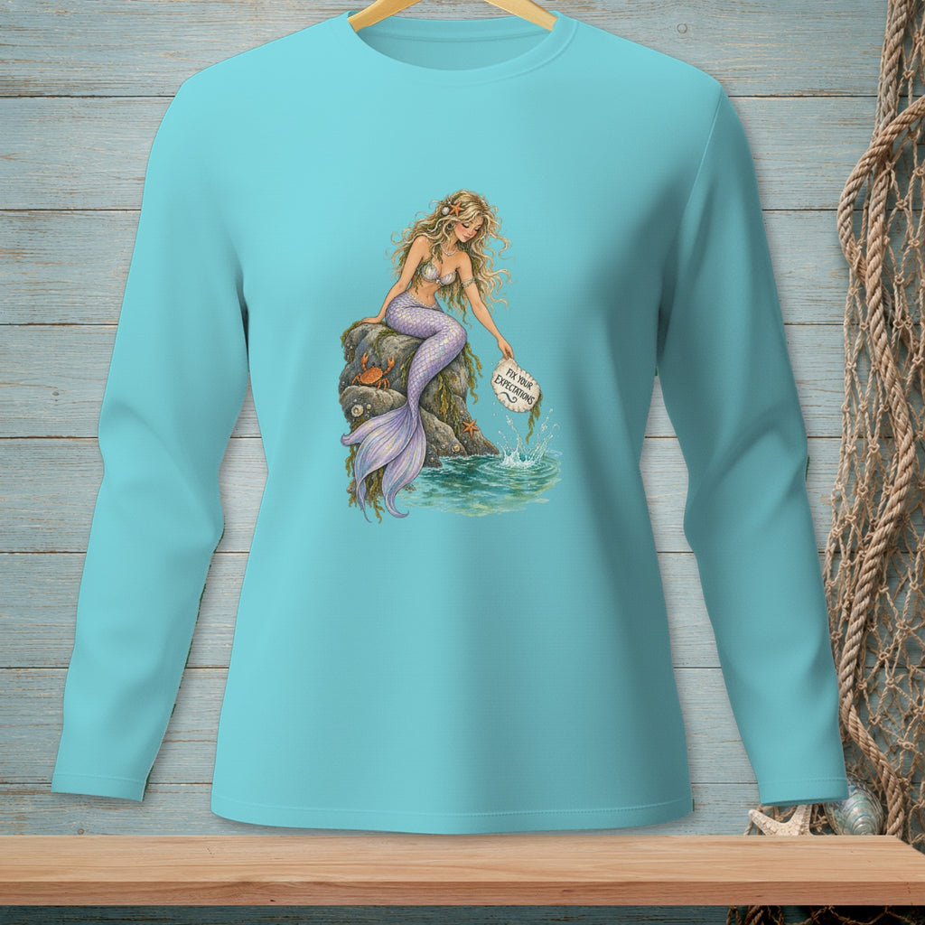 Long-sleeve shirt with a mermaid sitting on a rock, holding a sign that reads "Fix Your Expectations."