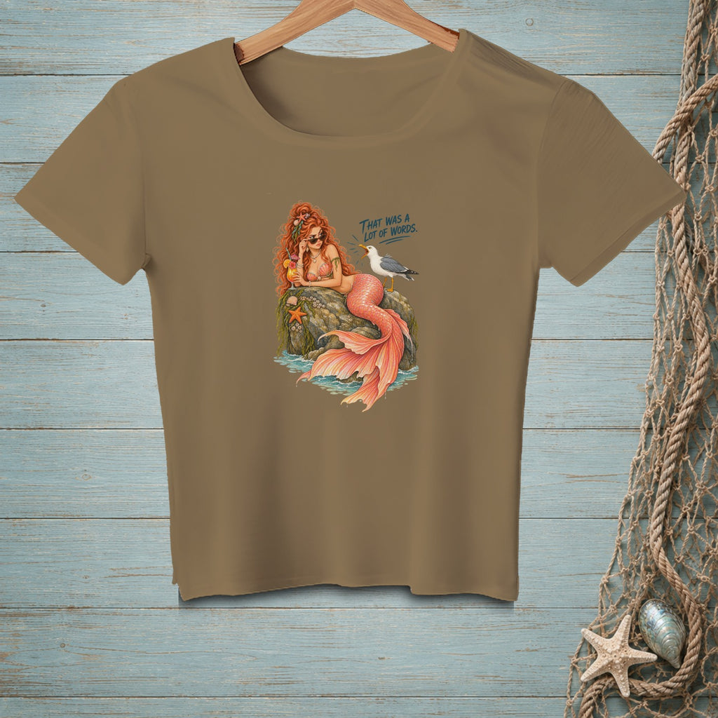 Mermaid relaxing on rock with drink, seagull, and text "That was a lot of words."