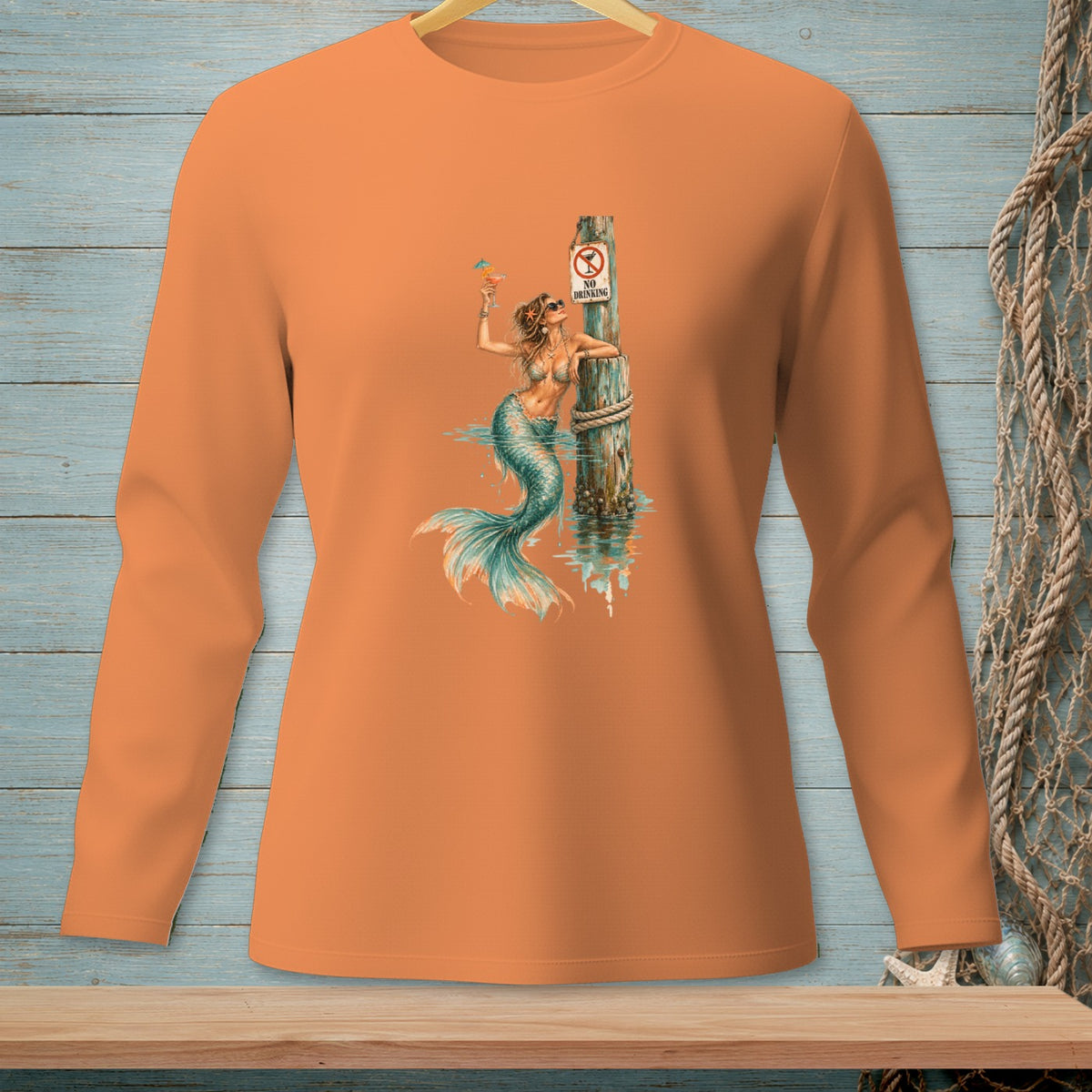 Orange long-sleeve shirt with a mermaid holding a drink by a "No Drinking" sign.