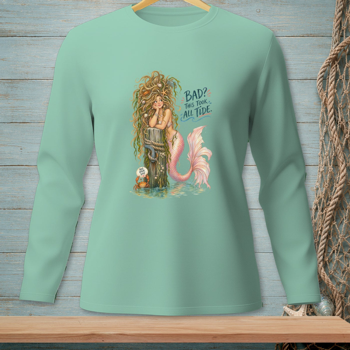 Mint long sleeve shirt with a mermaid graphic and text "BAD? THIS TOOK ALL TIDE."