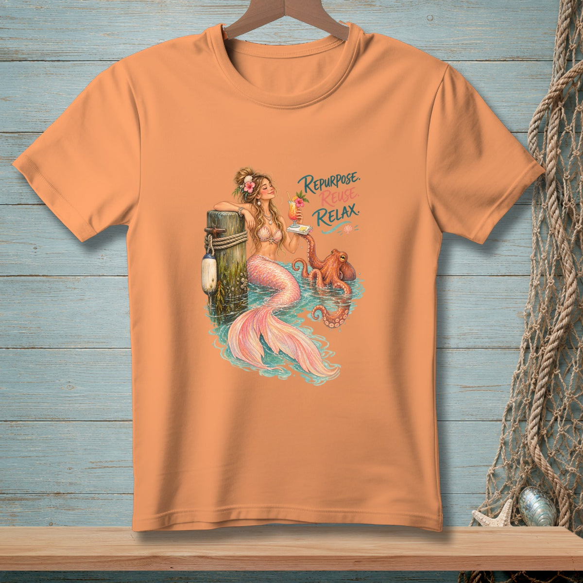 Peach t-shirt with mermaid, octopus, and text "Repurpose. Reuse. Relax."