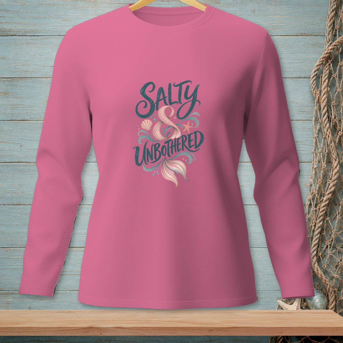 Pink long-sleeve shirt with "Salty & Unbothered" and mermaid tail graphic.