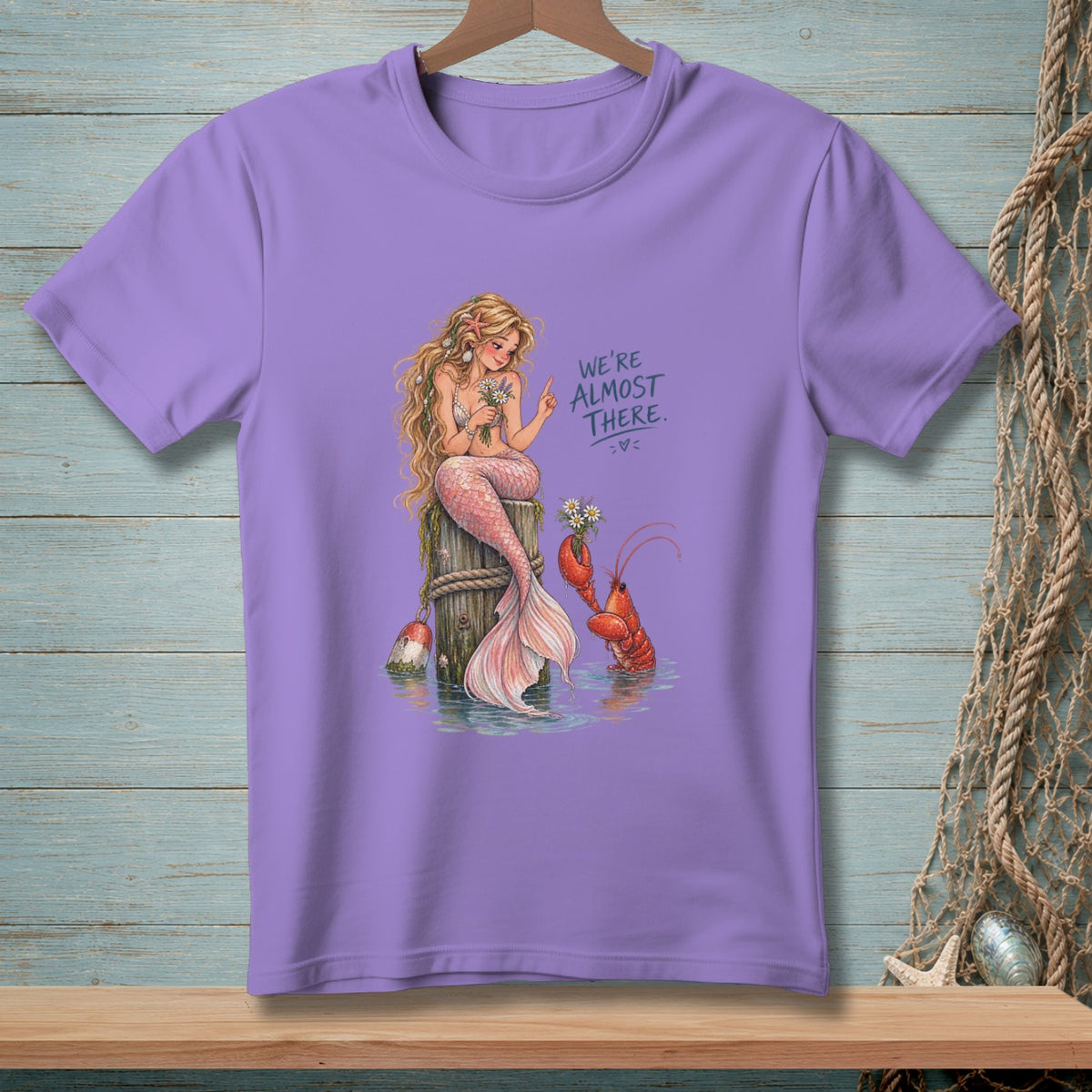 Mermaid and lobster with flowers, text "We're Almost There."
