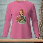 Pink long-sleeve shirt with a mermaid, crab, and drink graphic on a rock.