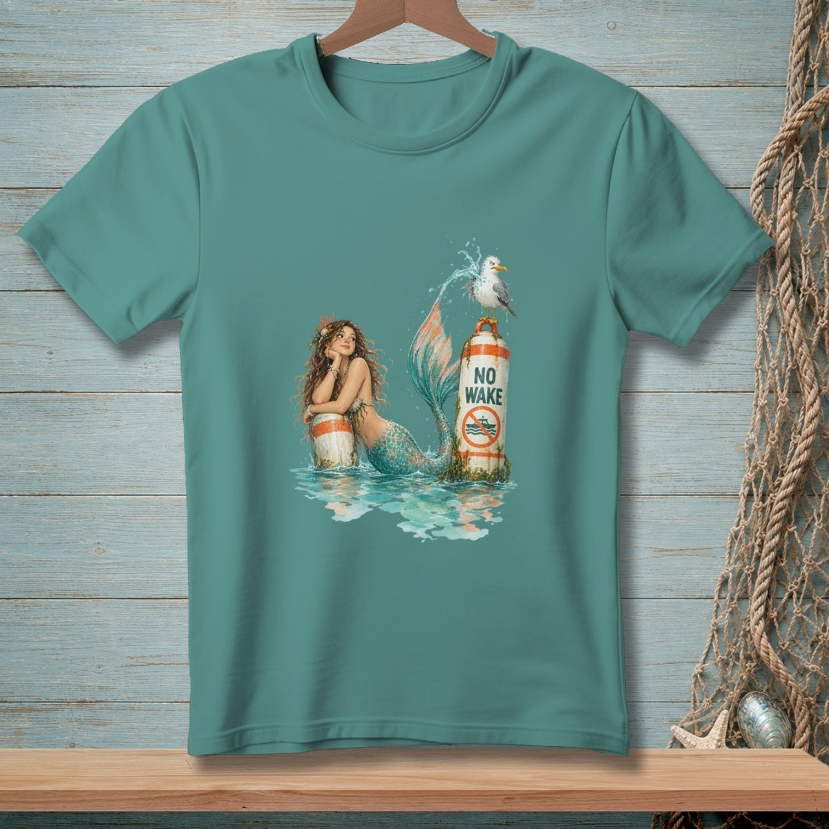 Mermaid resting on a buoy with "No Wake" text and a seagull.