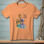 Orange t-shirt with graphic of a mermaid on a dock and text "THIS IS THE EFFORT".