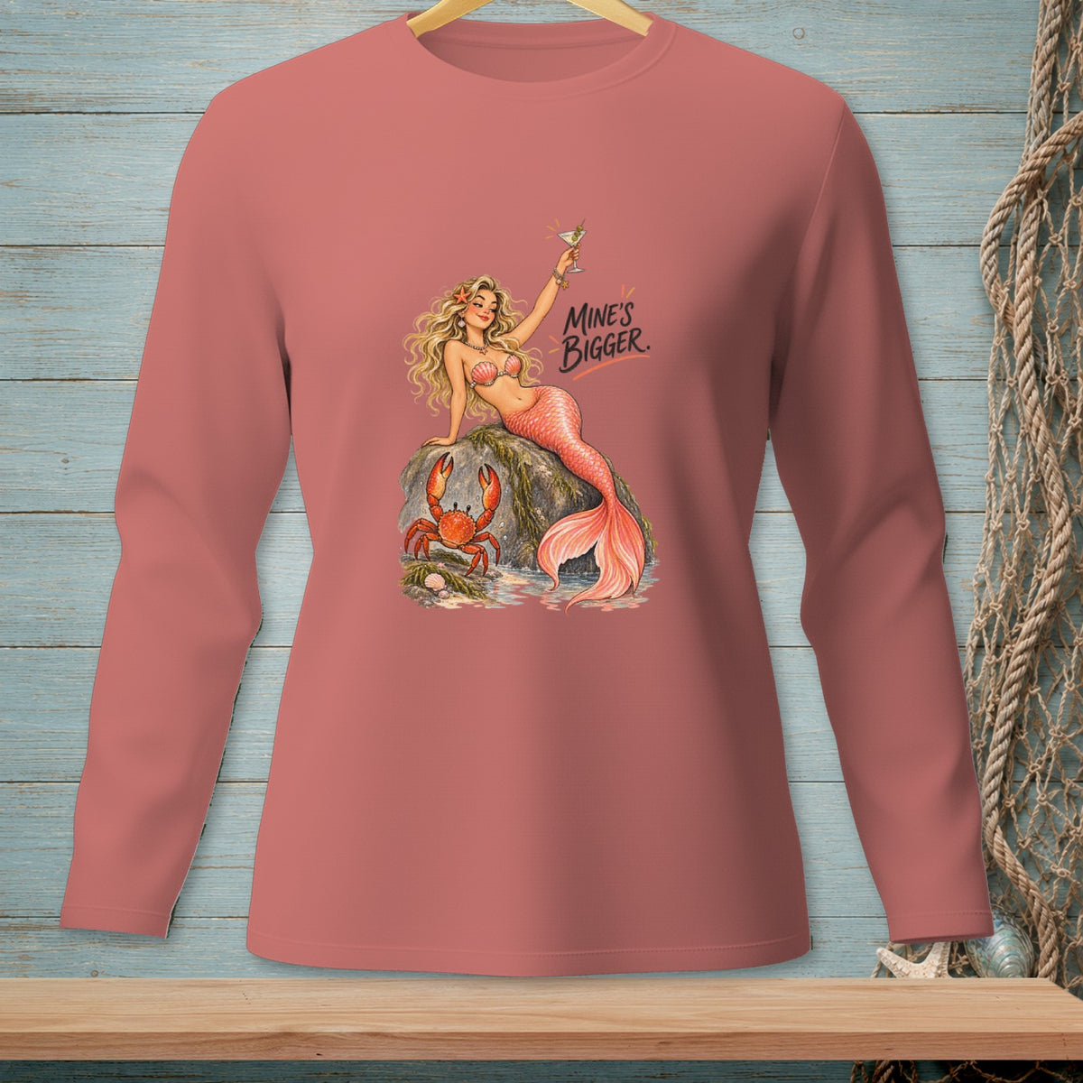 Long-sleeve shirt with mermaid, crab, and "Mine's Bigger." text graphic.