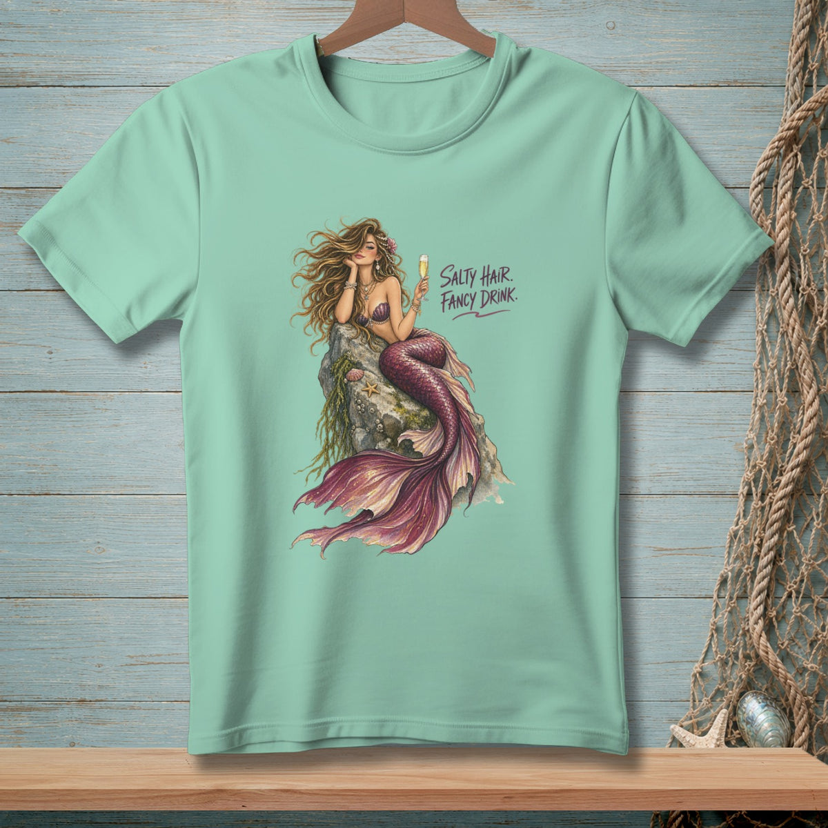 Mermaid on rock with drink, text "Salty Hair. Fancy Drink."