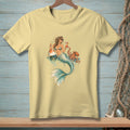 Yellow t-shirt featuring a mermaid holding cocktails with an octopus and buoy.