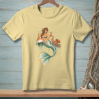 Yellow t-shirt featuring a mermaid holding cocktails with an octopus and buoy.