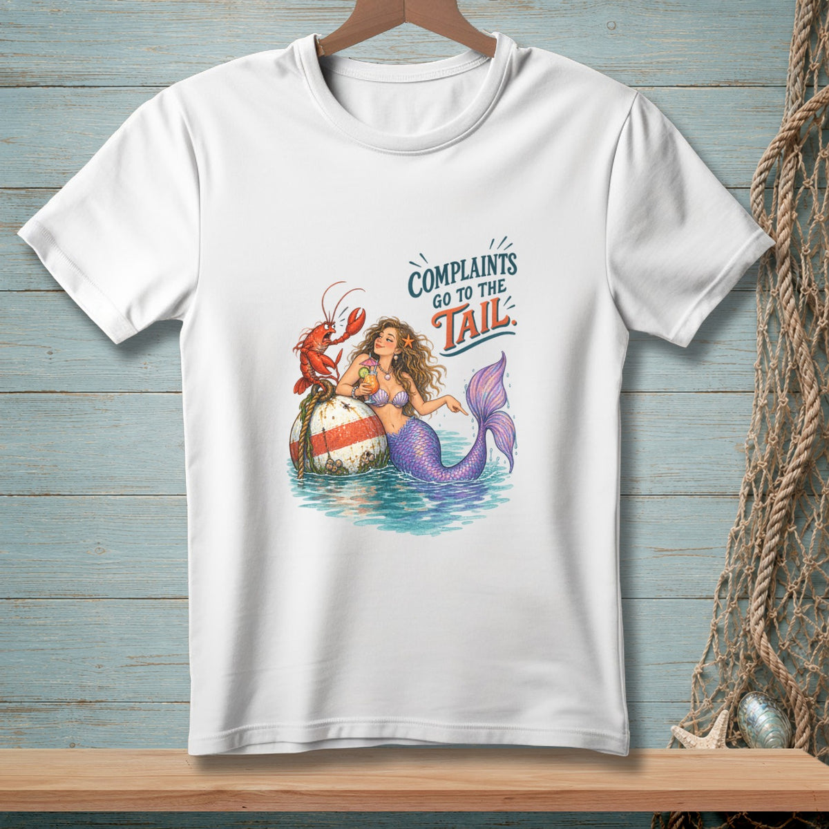 White t-shirt with mermaid, lobster, and text "Complaints Go To The Tail".