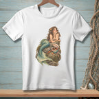 White t-shirt with a watercolor illustration of a mermaid resting on rocks near treasures.