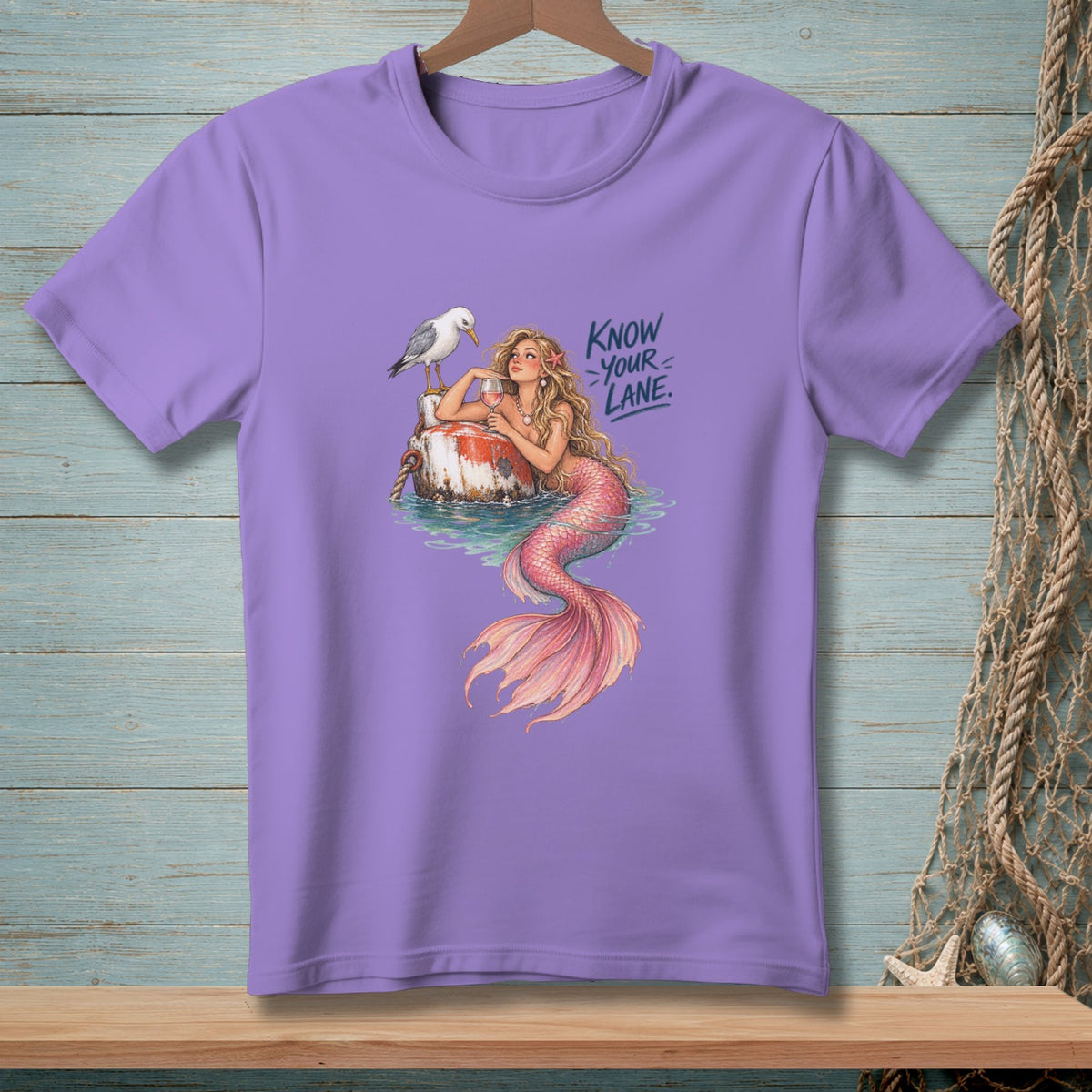 Lavender t-shirt with a mermaid, seagull, and the text "Know Your Lane."