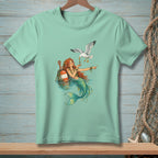 Mermaid holding pearl for seagull, with buoy in water.