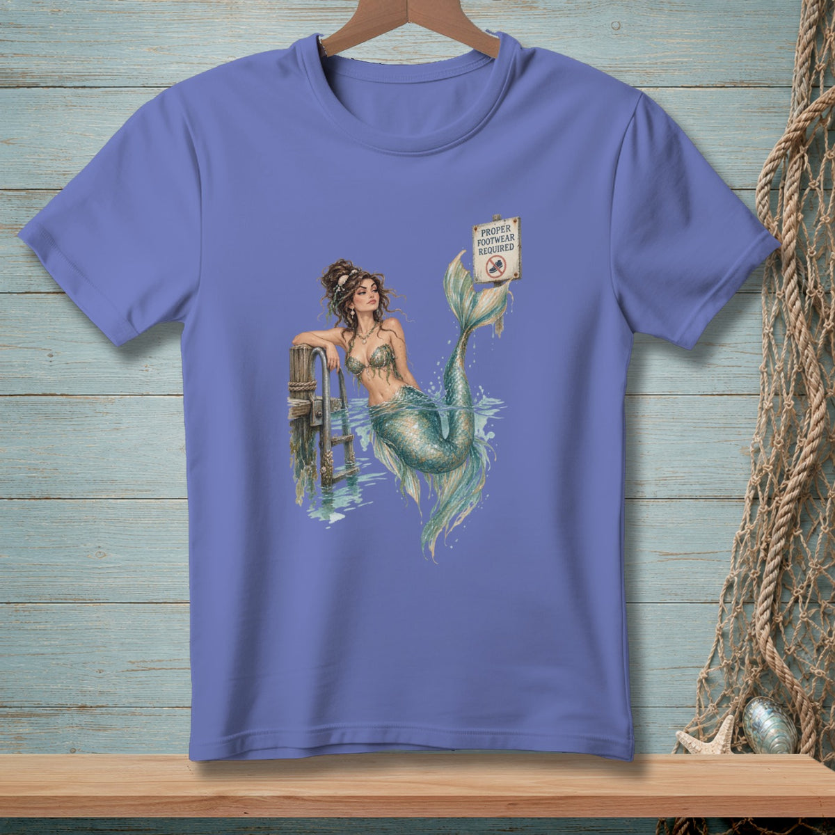 Mermaid lounging by a dock with "Proper Footwear Required" sign.