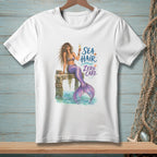 White t-shirt with mermaid illustration and text "Sea Hair Zero Care".