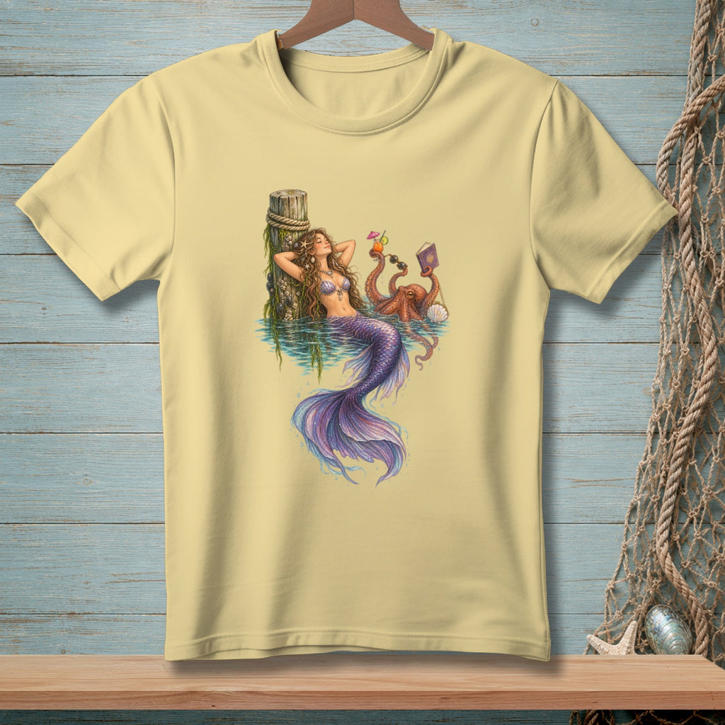 A mermaid reclines by a dock with an octopus holding drinks and sunglasses.