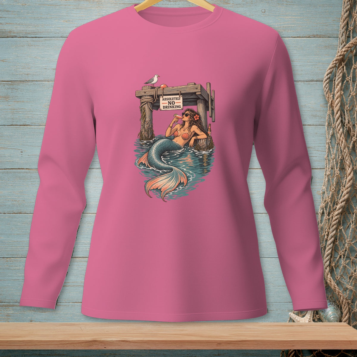Pink long-sleeve shirt with a mermaid drinking under a sign that reads "Absolutely No Drinking."