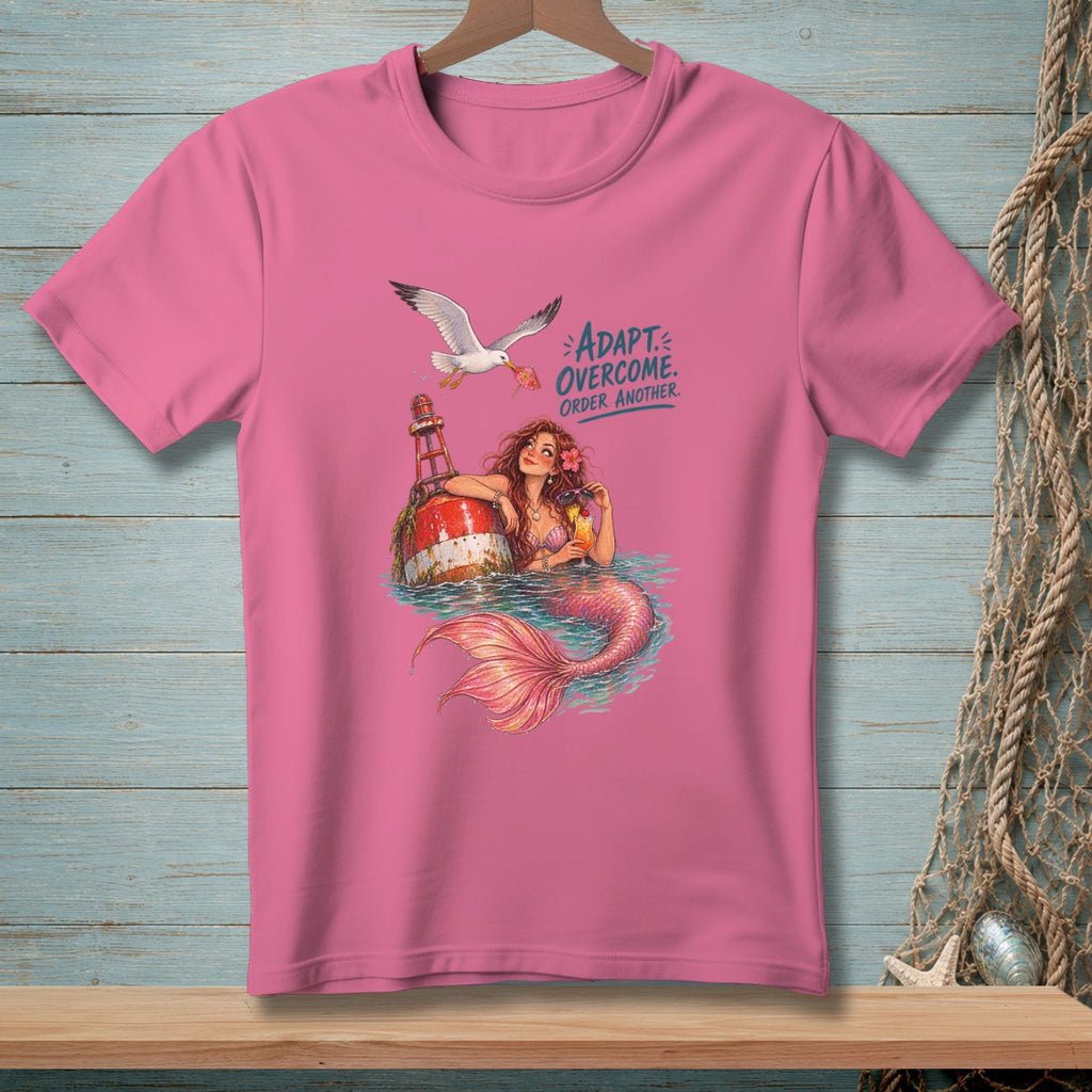 Pink t-shirt with mermaid, seagull, and text: Adapt. Overcome. Order Another.