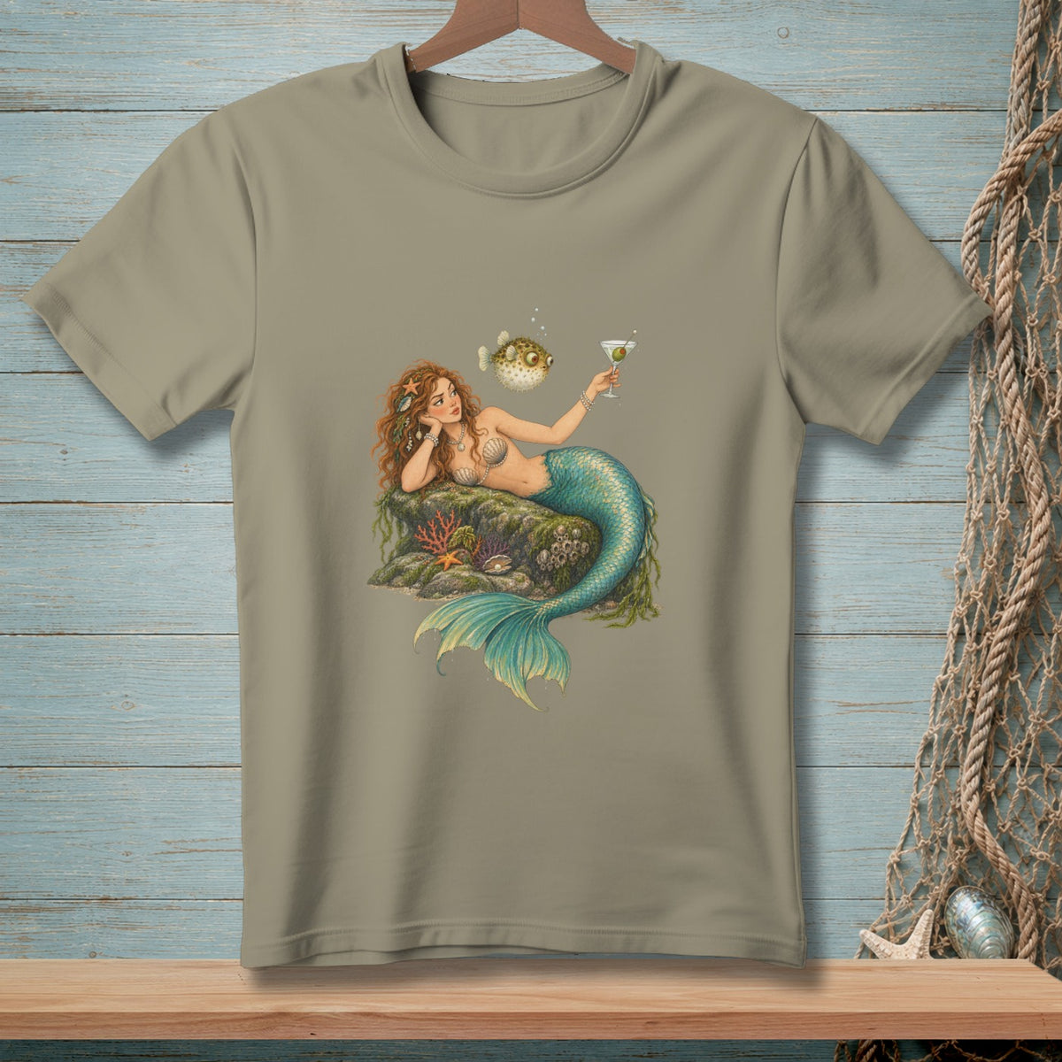 T-shirt featuring a mermaid with a blue tail holding a martini glass and a pufferfish.