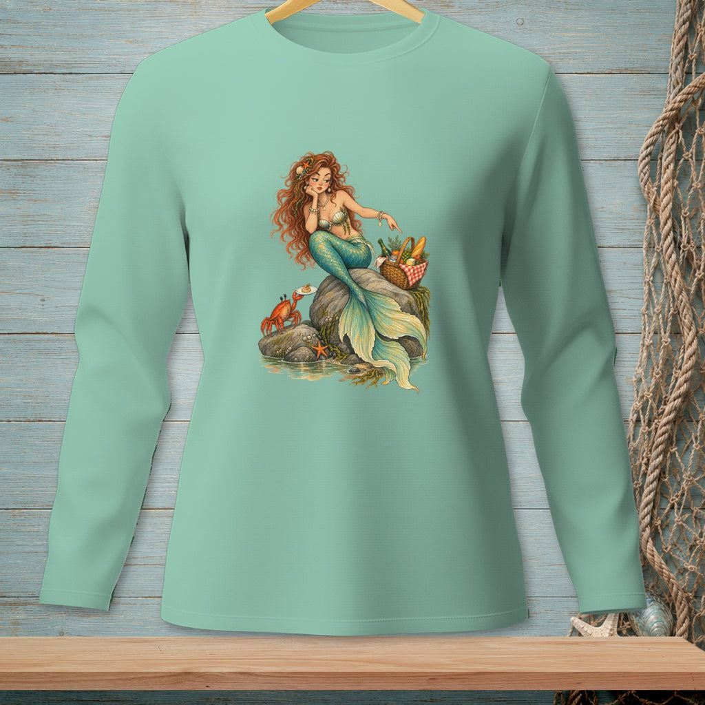 Mermaid with picnic basket and crab on rocks by the water.