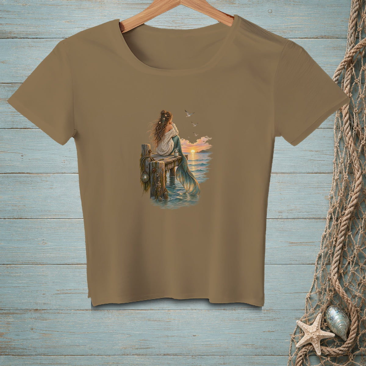 T-shirt with a mermaid sitting on a dock watching a sunset.