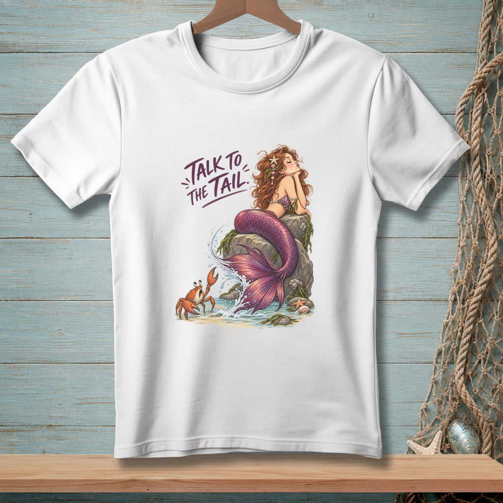 White t-shirt featuring a mermaid on a rock with a crab and the text "TALK TO THE TAIL".