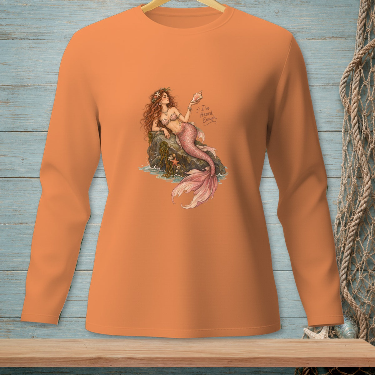 Orange long-sleeve shirt with a mermaid holding a seashell and text "I've Heard Enough."