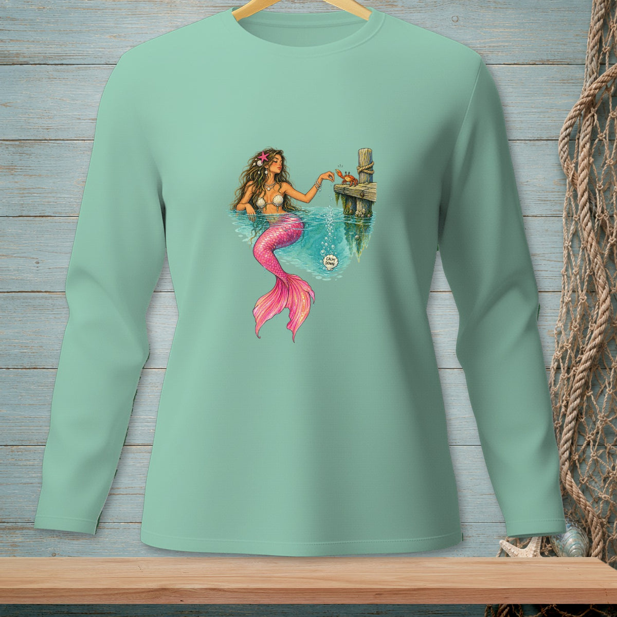 Illustration of a mermaid interacting with a crab on a dock with a "Calm Down" speech bubble.