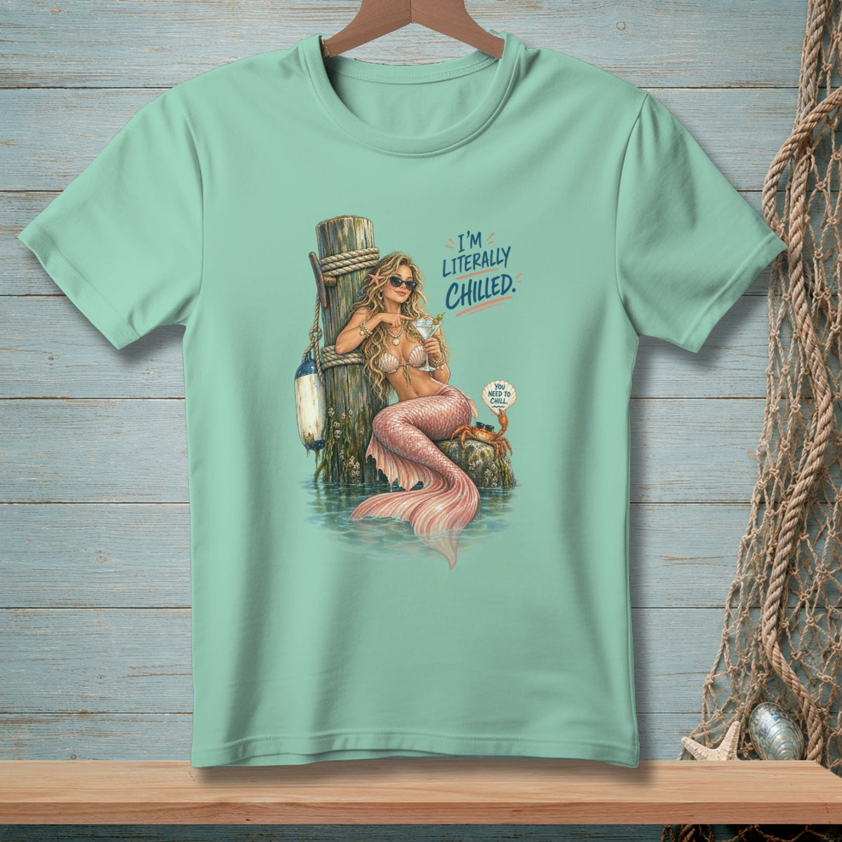 Mermaid with drink on pier, text "I'M LITERALLY CHILLED."