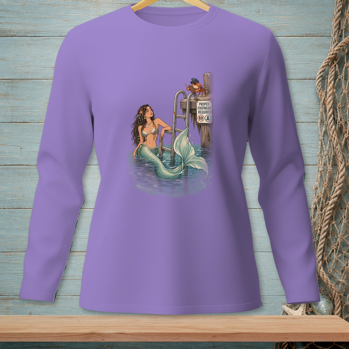 Lavender long-sleeve shirt with a graphic of a mermaid, a crab, and a sign.