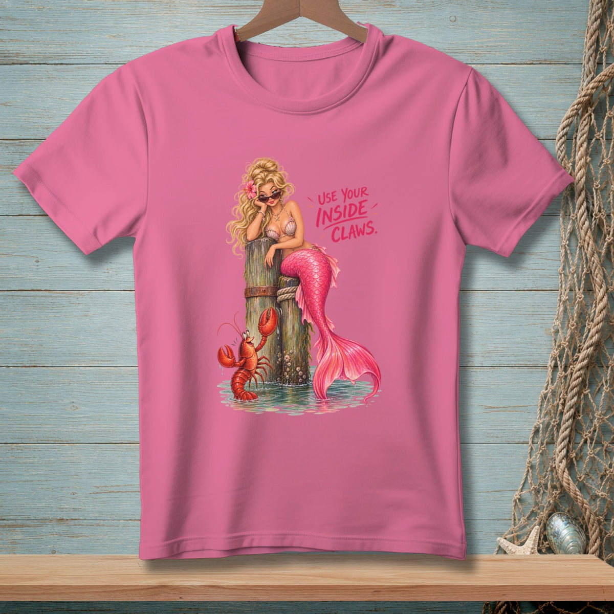Pink t-shirt with a mermaid and lobster graphic that reads "Use your inside claws."