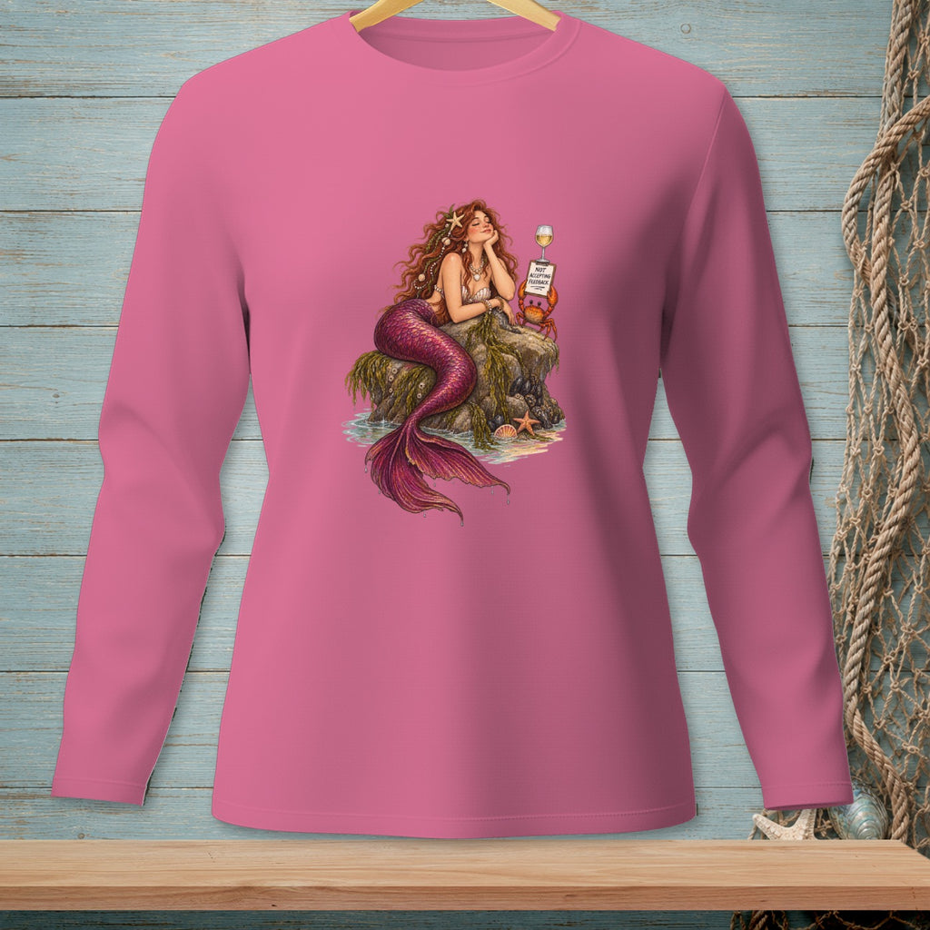 Pink long-sleeved shirt featuring a mermaid with a red tail sitting on rocks, holding a sign.