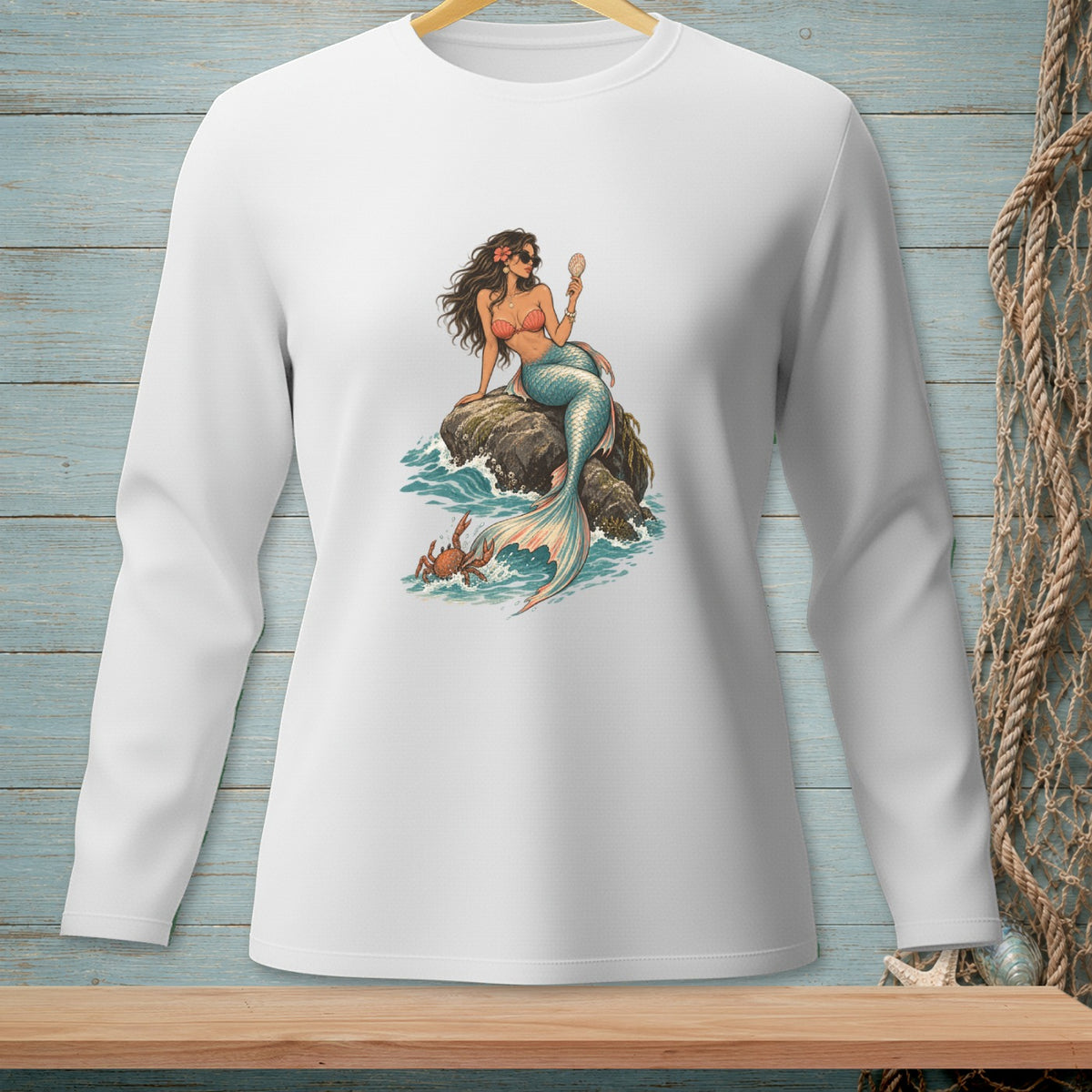 White long-sleeve shirt featuring a mermaid on a rock with a crab and seashell.