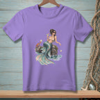 Mermaid with crab and drink sits on a rock in the water.
