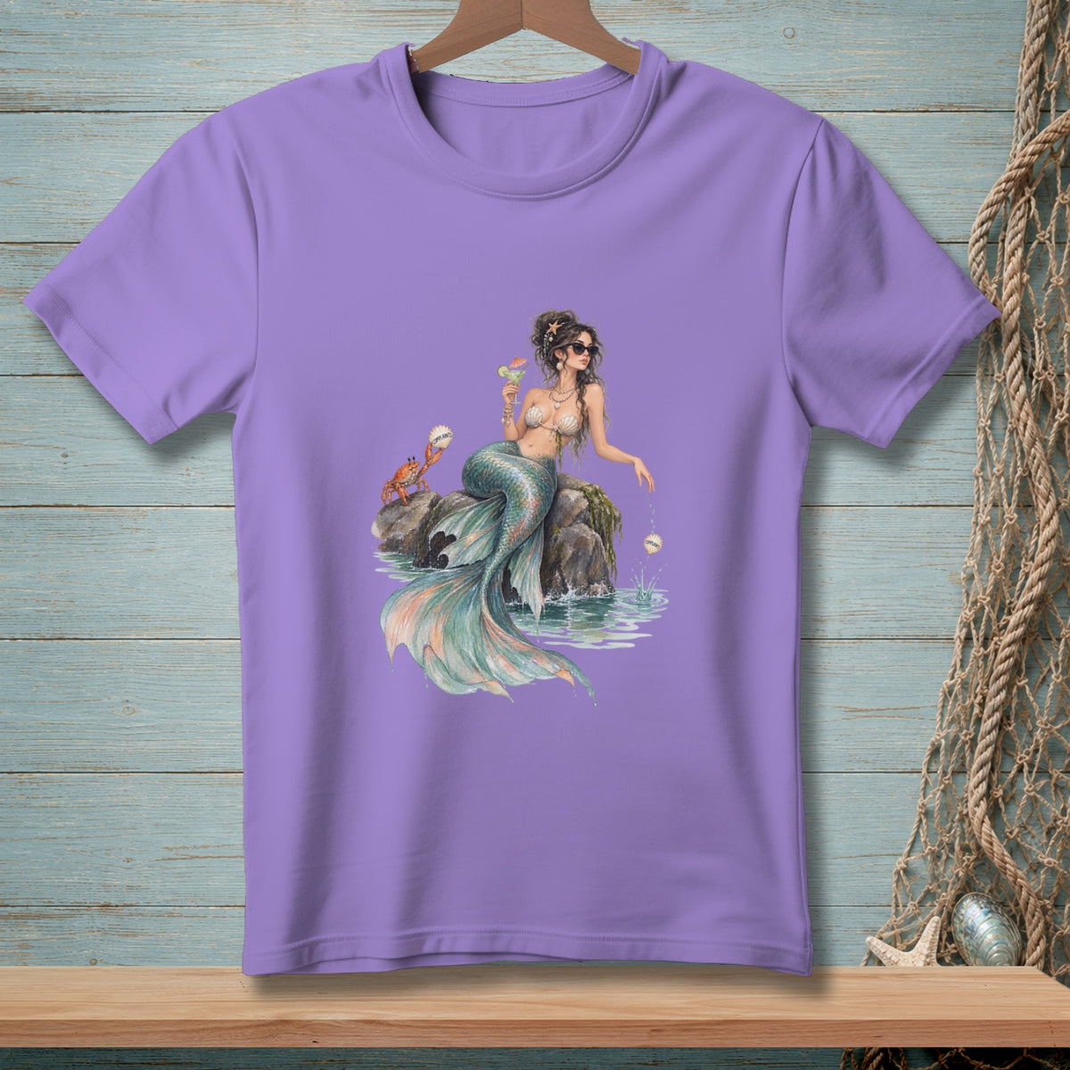 Mermaid with crab and drink sits on a rock in the water.